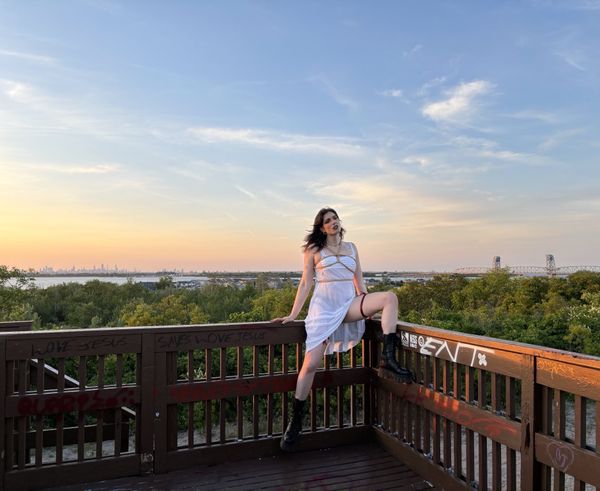 twilight in a sheer white dress, posed in front of the new york city skyline